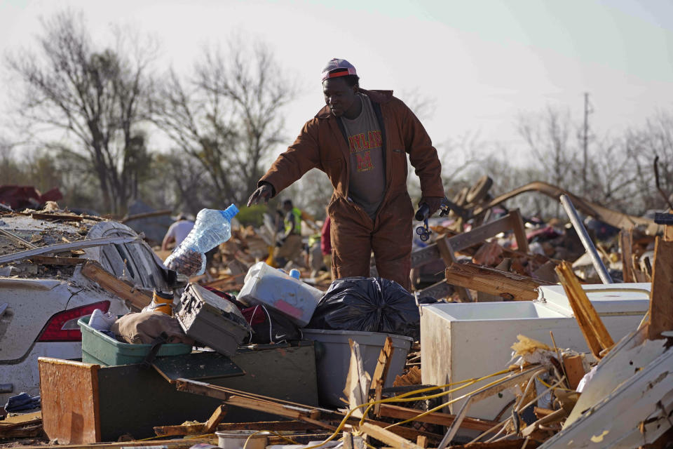 A resident looks through the piles of debris, insulation, and home furnishings to see if anything is salvageable at a mobile home park in Rolling Fork, Miss., Saturday, March 25, 2023. Emergency officials in Mississippi say several people have been killed by tornadoes that tore through the state on Friday night, destroying buildings and knocking out power as severe weather produced hail the size of golf balls moved through several southern states. (AP Photo/Rogelio V. Solis)