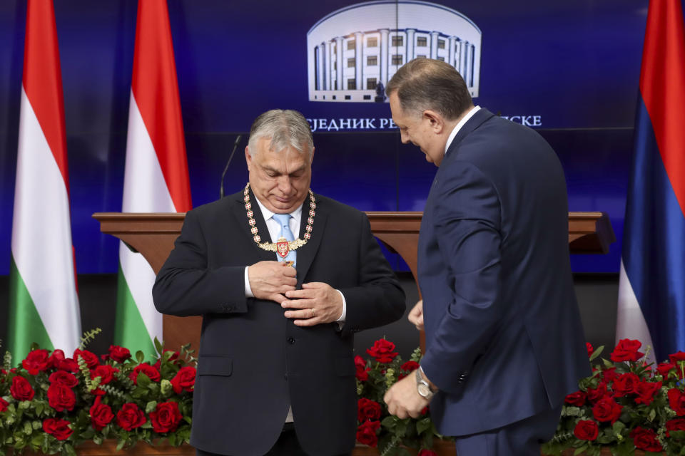 In this photograph made available by the Republika Srpska Presidential Press Service, Hungary's Prime Minister Viktor Orban, left, receives the Order of Republika Srpska from Bosnian Serb leader Milorad Dodik during his visit in Banja Luka, Bosnia, Friday, April 5, 2024. Orban is on a two-day visit to Bosnia and Herzegovina. (Republika Srpska Presidential Press Service via AP)
