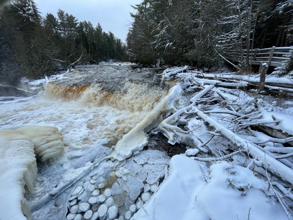 Pancake ice — unusual ice disc formations — can be seen in the pool in the foreground beneath the Lower Falls at Tahquamenon Falls State Park in this December 2022 photo.