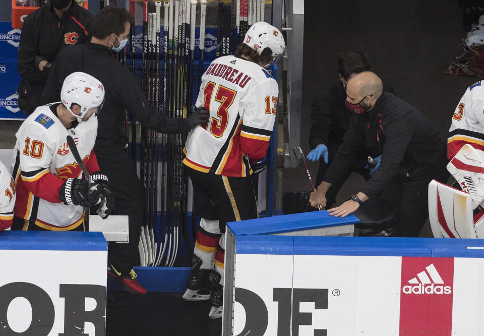 Calgary Flames' Johnny Gaudreau (13) leaves the ice with an injury against the Winnipeg Jets during the third period of an NHL qualifying round game, in Edmonton, Alberta, Thursday, Aug. 6, 2020. (Jason Franson=/The Canadian Press via AP)