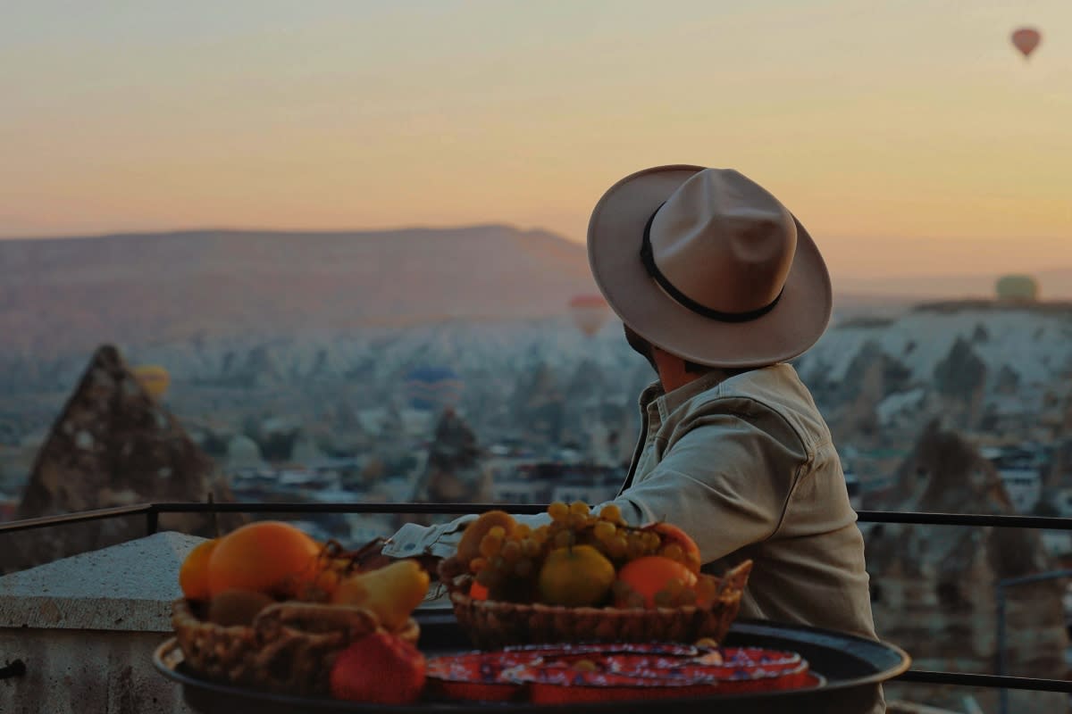Back View of a Person Watching Hot Air Balloons Flying over Cappadocia, Turkey