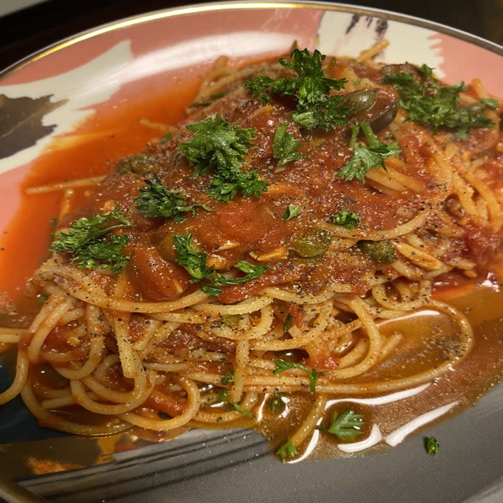 pasta with tomato sauce, capers, olives, and parsley. 