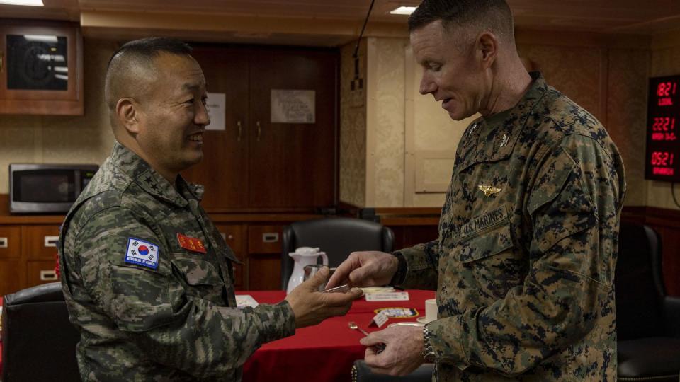 Lt. Gen. Kim Gye-hwan, left, commandant of the South Korean Marine Corps, receives a challenge coin from U.S. Marine Corps Col. Samuel Meyer, who leads the 13th Marine Expeditionary Unit, during a ship tour aboard the amphibious assault ship Makin Island on March 28, 2023. (Cpl. Carl Matthew Ruppert/U.S. Marine Corps)