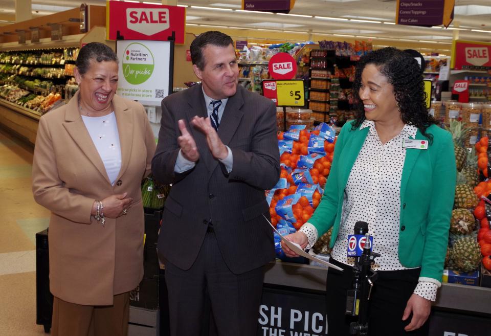 From left, Sydne Marrow, Chief of Staff to Brockton Mayor Robert Sullivan, and Sullivan listen as Christina Marcelino, the manager of the 932 North Montello St. Stop & Shop, confirms the store will be remaining open during a news conference on Monday, April 10, 2023.