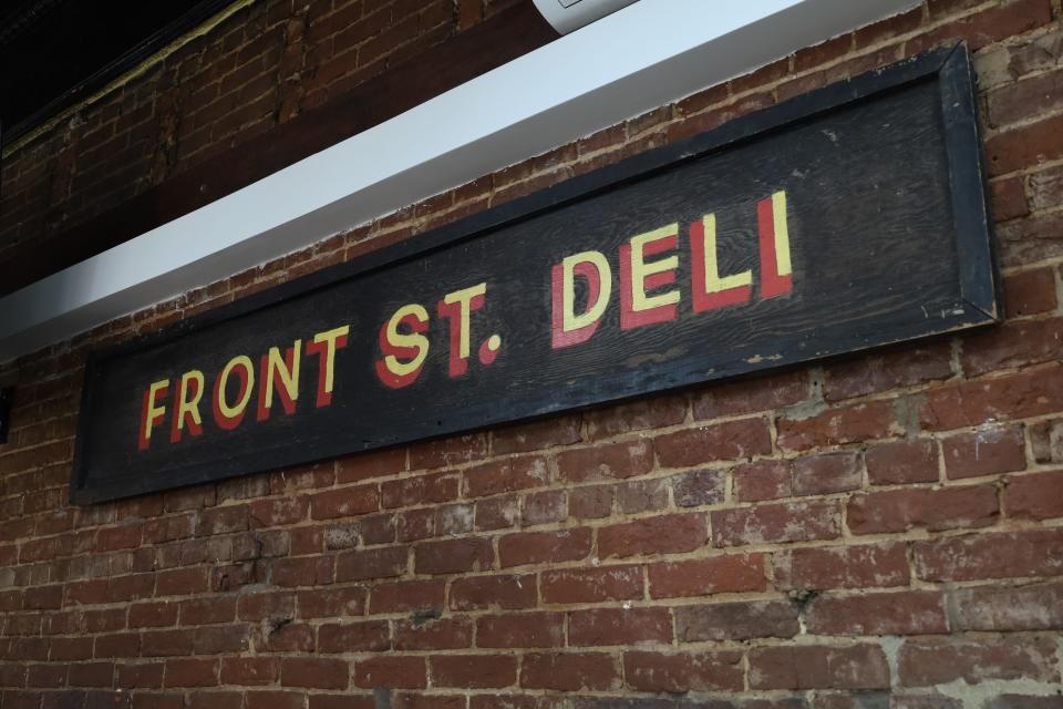 The original sign from Front St. Deli still hangs on the wall 48 years later, as seen on Monday, March 18, 2024. The building's original brick from 1853 remains as well.