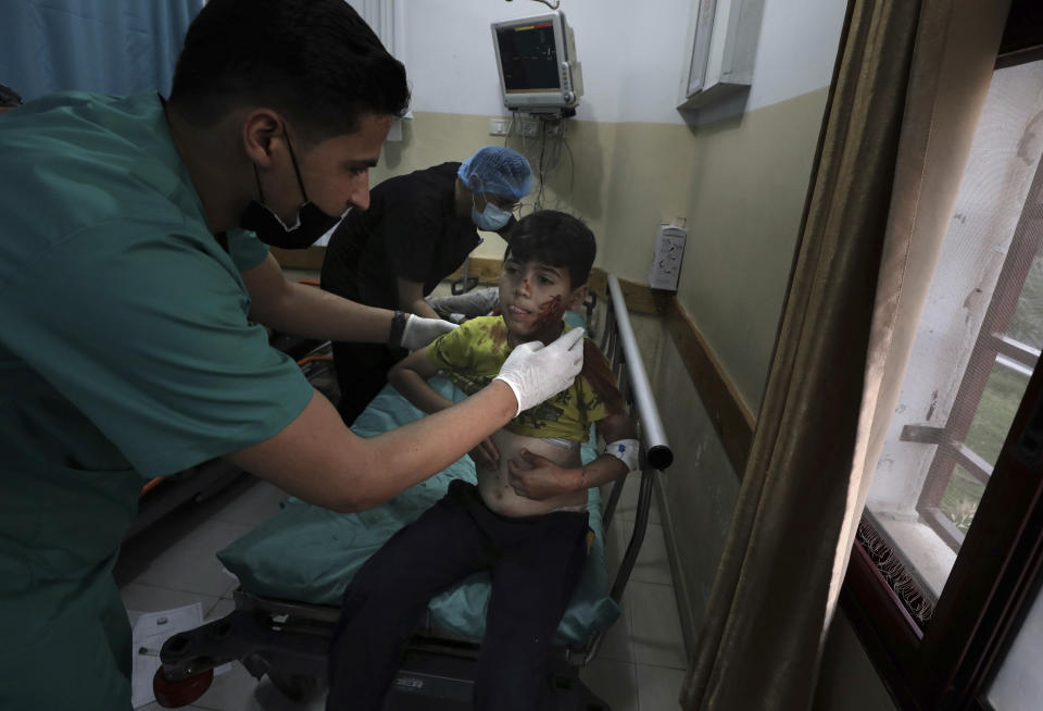 A medic treats a wounded boy following an explosion in the town of Beit Lahiya, northern Gaza Strip, on Monday, May 10, 2021, during a conflict between Hamas and Israel. (AP Photo/Mohammed Ali)