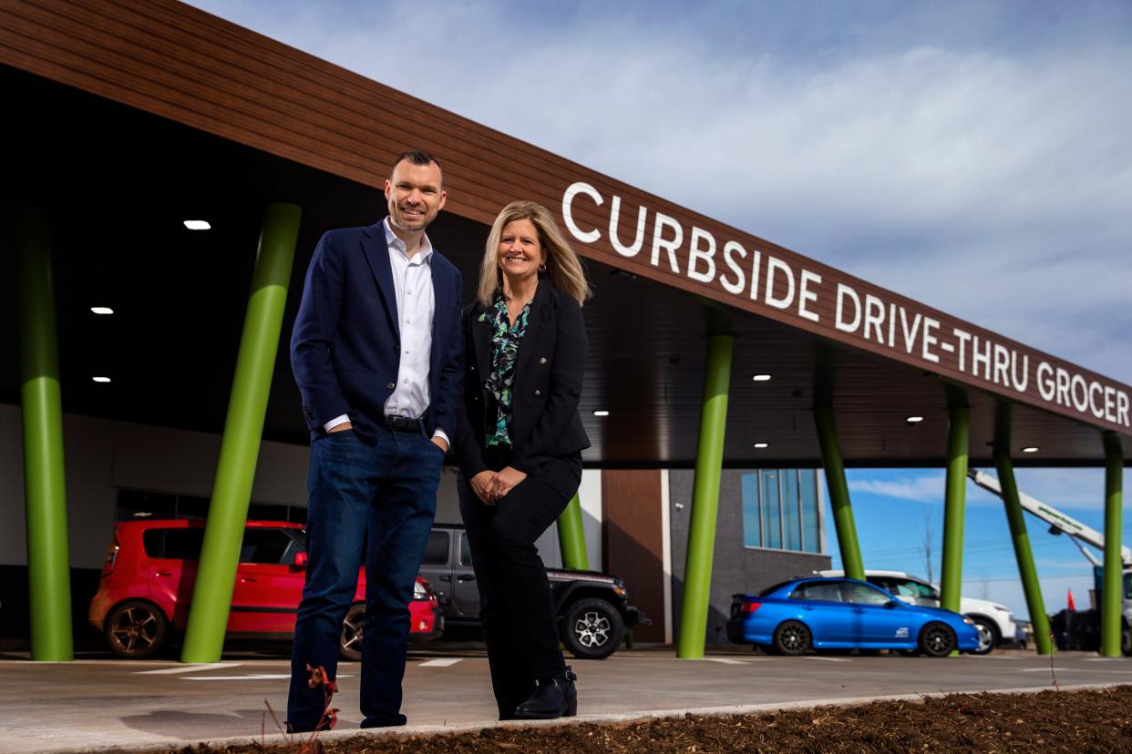 Alex Ruhter and Jennifer Neef, owners of JackBe grocery, pose for a photo outside their drive-thru grocery store in Oklahoma City.