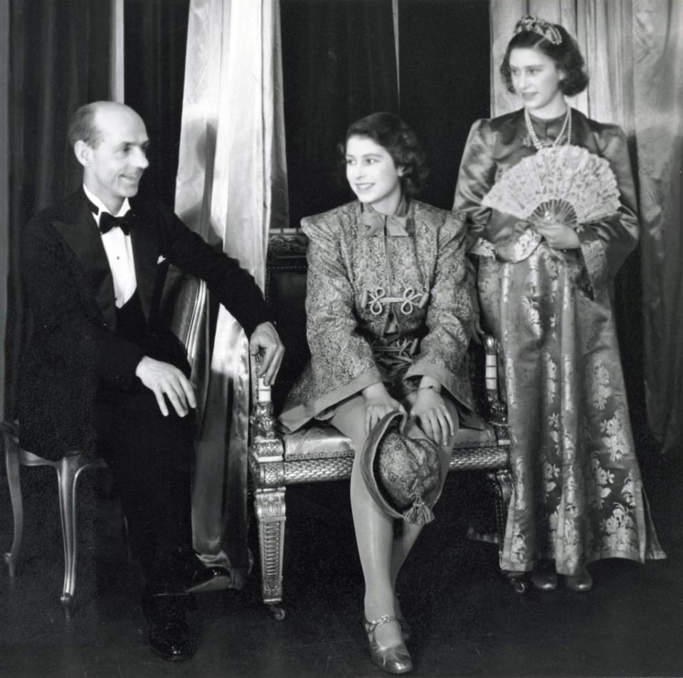 Princess Elizabeth and Princess Margaret, dressed in costumes for the 1943 performance of Aladdin, with headmaster Hubert Tanner (Royal Collection/Queen Elizabeth II 2021/PA) (PA Media)