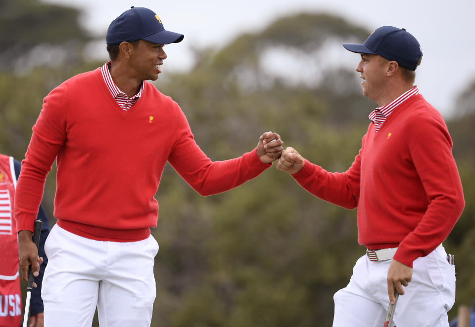 U.S. team player and captain Tiger Woods, left, and teammate Justin Thomas celebrate after Woods birdied the 5th during their fourball match at the Royal Melbourne Golf Club in the opening rounds of the President's Cup golf tournament in Melbourne, Thursday, Dec. 12, 2019. (AP Photo/Andy Brownbill)