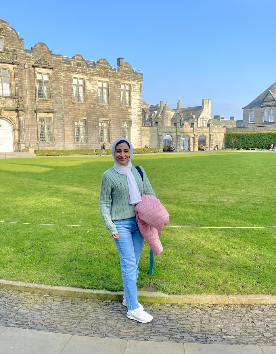 Israa standing in front of a building at the University of St Andrews