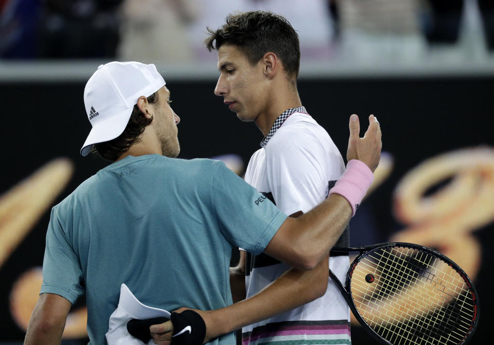 France's Lucas Pouille, left, is congratulated by Australia's Alexei Popyrin after winning their third round match at the Australian Open tennis championships in Melbourne, Australia, Sunday, Jan. 20, 2019. (AP Photo/Kin Cheung)