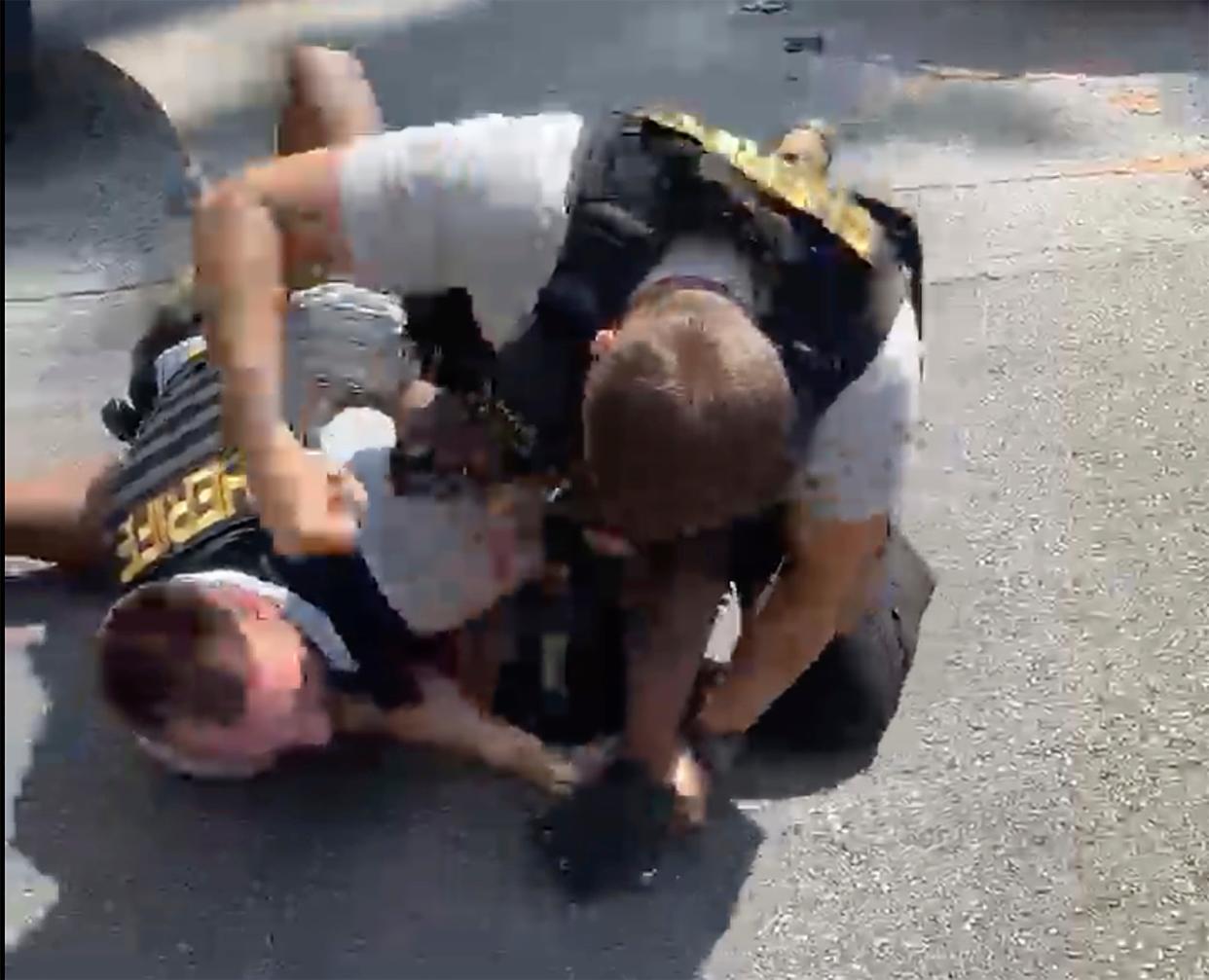 A screen grab from a video shows a Clayton County deputy punching Roderick Williams during a traffic stop (Juanita Davis/Courtesy of The Cochran Firm via AP)