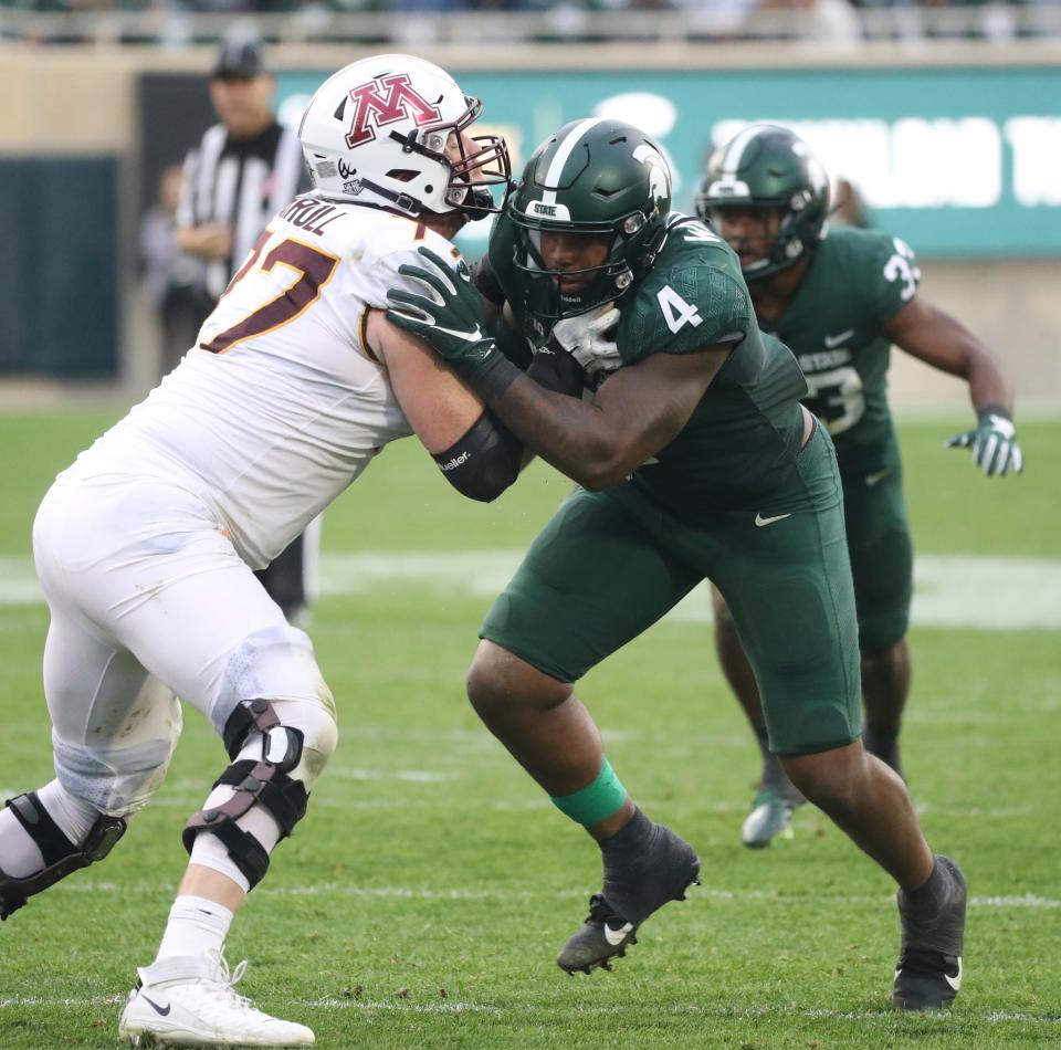 Michigan State Spartans linebacker Jacoby Windmon rushes against Minnesota Golden Gophers offensive lineman Quinn Carroll (77) during the second half at Spartan Stadium, Saturday, Sept. 24, 2022.