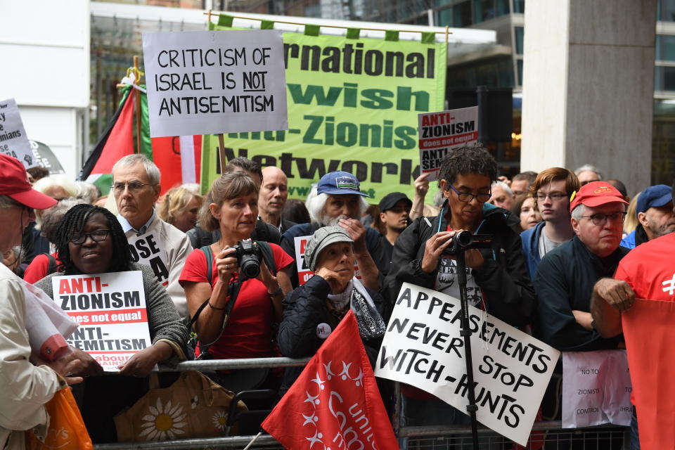 Activists react outside a meeting of the Labour National Executive Committee in London Tuesday Sept. 4, 2018 which is expected to decide on whether to adopt the International Holocaust Remembrance Alliance (IHRA) definition of anti-Semitism and its examples, which has been the subject of a bitter row within the party over recent months. (Stefan Rousseau/PA via AP)