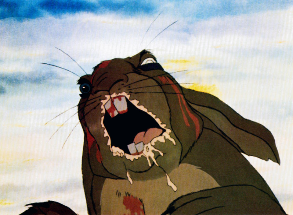 An animated rabbit with an open mouth and blood on its teeth and body