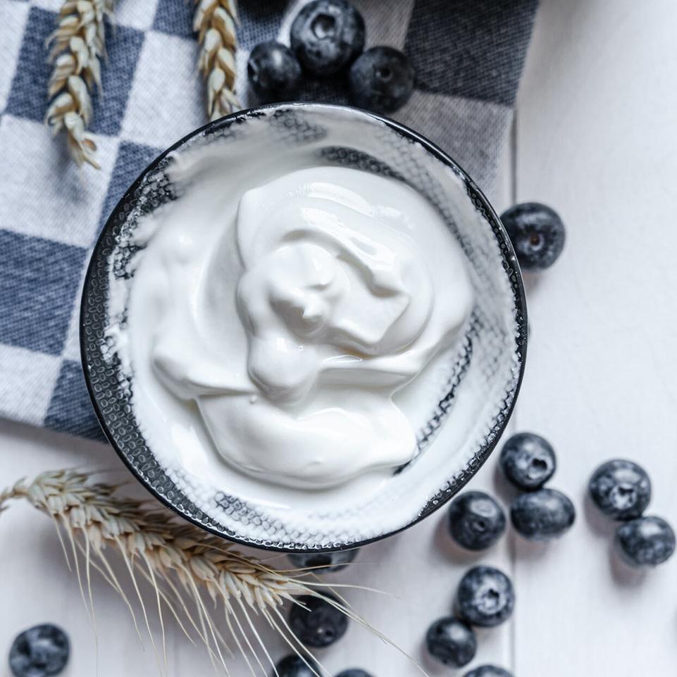 yogurt in bowl on wooden table. healthy eating