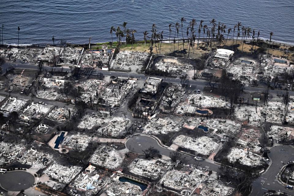 An aerial image taken on August 10, 2023 shows destroyed homes and buildings burned to the ground in Lahaina in the aftermath of wildfires in western Maui, Hawaii. At least 36 people have died after a fast-moving wildfire turned Lahaina to ashes, officials said August 9, 2023 as visitors asked to leave the island of Maui found themselves stranded at the airport. The fires began burning early August 8, scorching thousands of acres and putting homes, businesses and 35,000 lives at risk on Maui, the Hawaii Emergency Management Agency said in a statement. (Photo by Patrick T. Fallon / AFP) (Photo by PATRICK T. FALLON/AFP via Getty Images)