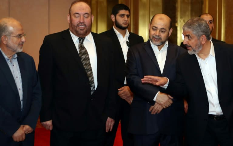 Khaled Meshaal (R) speaks with Hamas officials ahead of their conference in the Qatari capital, Doha on May 1