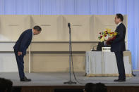 Japan's outgoing Prime Minister, Yoshihide Suga, left, bows to former Foreign Minister Fumio Kishida after Kishida was announced the winner of the Liberal Democrat Party leadership election in Tokyo Wednesday, Sept. 29, 2021. Kishida won the governing party leadership election on Wednesday and is set to become the next prime minister, facing the imminent task of addressing a pandemic-hit economy and ensuring a strong alliance with Washington to counter growing regional security risks. (Carl Court/Pool Photo via AP)