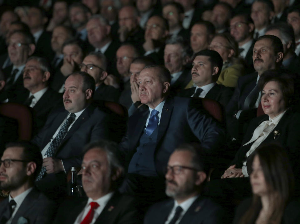 Turkey's President Recep Tayyip Erdogan centre, attends an event in Ankara, Turkey, Monday, Dec. 30, 2019. Turkey's government on Monday submitted a motion to parliament seeking approval to deploy troops to Libya, to help authorities in Tripoli defend the city from an offensive by rival forces, arguing that the conflict in the North African country could escalate into a civil war and threaten Turkey's interests.(Presidential Press Service via AP, Pool)
