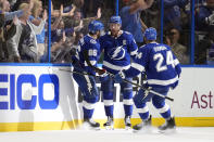 Tampa Bay Lightning center Steven Stamkos (91) celebrates his goal against the Florida Panthers with right wing Nikita Kucherov (86) and defenseman Matt Dumba (24) during the third period in Game 4 of an NHL hockey Stanley Cup first-round playoff series, Saturday, April 27, 2024, in Tampa, Fla. (AP Photo/Chris O'Meara)