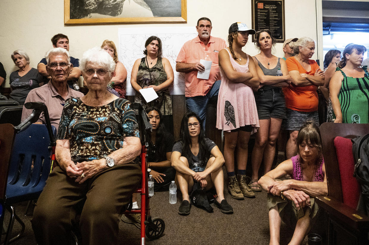 Residents affected by the Oak Fire listen to updates from fire officials during a community meeting in Mariposa County, Calif., on Sunday, July 24, 2022. (AP Photo/Noah Berger)