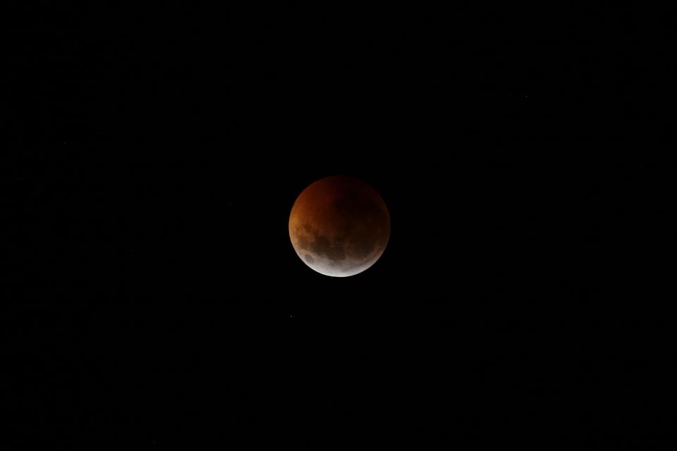 This photo shows the moon partially covered during a total lunar eclipse seen over Asuncion, Paraguay, Monday, Jan. 21, 2019. The entire eclipse will exceed three hours. Totality - when the moon's completely bathed in Earth's shadow - will last an hour. Expect the eclipsed, or blood moon, to turn red from sunlight scattering off Earth's atmosphere. (AP Photo/Jorge Saenz)