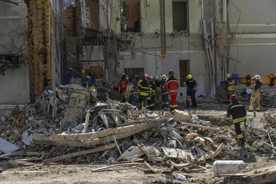 Rescue workers clear the rubble at the site of Okhmatdyt children's hospital hit by Russian missiles on Monday, in Kyiv, Ukraine, Tuesday, July 9, 2024. (AP Photo/Anton Shtuka)