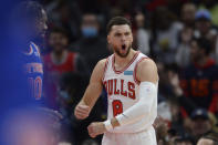 Chicago Bulls' Zach LaVine (8) celebrates after dunking while New York Knicks' Julius Randle (30) looks on during the first half of a NBA basketball game Sunday, Nov. 21, 2021 in Chicago. (AP Photo/Paul Beaty)