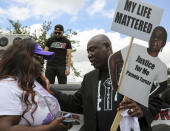 Attorney Benjamin Crump, right, talks with Chelsie Rubin, daughter of Pamela Turner, before a "Justice for Pamela Turner" rally on the two-year-anniversary of Turner's death, Thursday, May 13, 2021, in Baytown, Texas. Turner was fatally shot in 2019 by a police officer in the Houston suburb after a struggle over his stun gun. (Godofredo A. Vásquez/Houston Chronicle via AP)