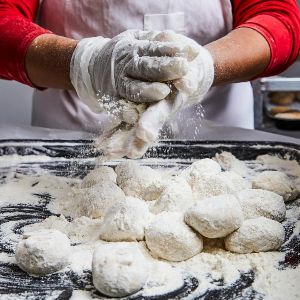 The H-E-B tortilla operation is a well-buttered machine. Roll dough balls, press, count, package.