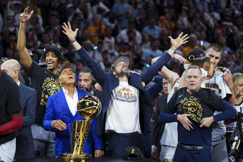 Denver Nuggets owners Josh, center right, and Stan Kroenke, center left, celebrate after the team won the NBA Championship with a victory over the Miami Heat in Game 5 of basketball's NBA Finals, Monday, June 12, 2023, in Denver. (AP Photo/Jack Dempsey)