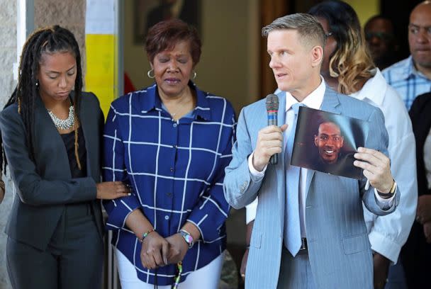 PHOTO: Attorney Bobby DiCello, right, holds up a photograph of Jayland Walker as Paige White, left, comforts Jayland's mother Pamela Walker during a press conference at St. Ashworth Temple on June 30, 2022, in Akron, Ohio. (Jeff Lange/USA Today Network)