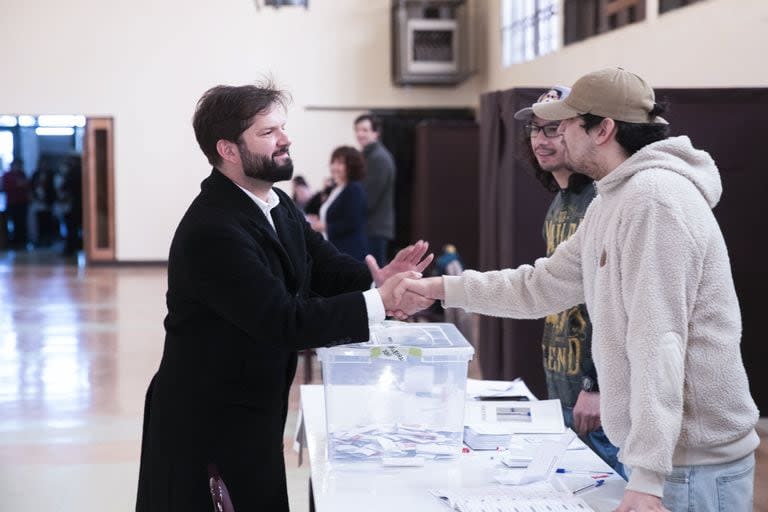 El presidente de Chile, Gabriel Boric, izquierda, llega para votar el borrador de una nueva constitución en Punta Arenas, Chile, domingo 17 de diciembre de 2023. Por segunda vez en otros tantos años, los chilenos votan en referéndum si sustituyen la actual Constitución, que se remonta a la dictadura militar del general Augusto Pinochet. (AP Photo/Andres Poblete)