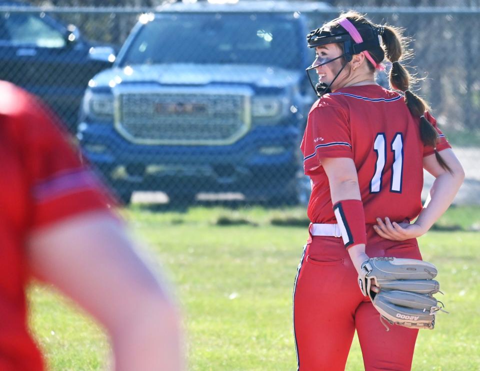 Boyne City's Lucy Uy jokes around with a teammate before the start of an inning in the home opener against Inland Lakes Monday in Boyne City.