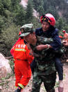 <p>A rescuer helps evacuate a woman following an earthquake in Jiuzhaigou in China’s southwestern Sichuan province on Aug. 9, 2017. (Photo: STR/AFP/Getty Images) </p>