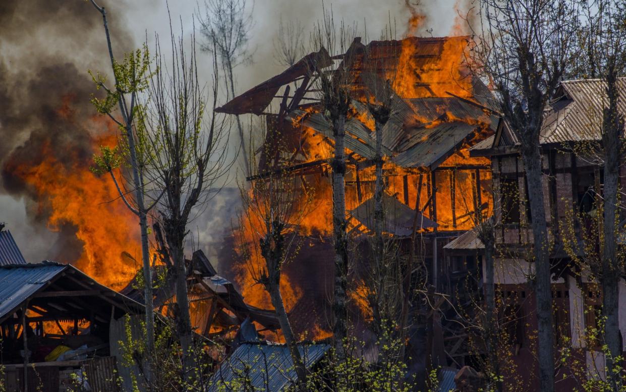 Homes are engulfed in flames where rebels have taken refuge from  Indian armed forces during a gun battle in Shopain south of Srinagar - Getty Images AsiaPac