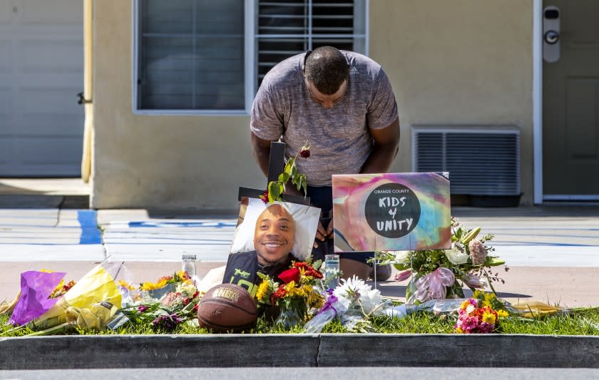 Phil Pascal of Las Vegas prays at a memorial for Kurt Andras Reinhold.