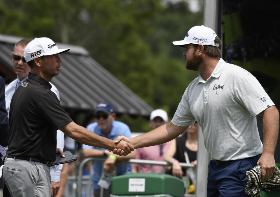 Chez Reavie shakes hands with Zack Sucher as they begin the third round of the Travelers Championship golf tournament, Saturday, June 22, 2019, in Cromwell, Conn. (AP Photo/Jessica Hill)