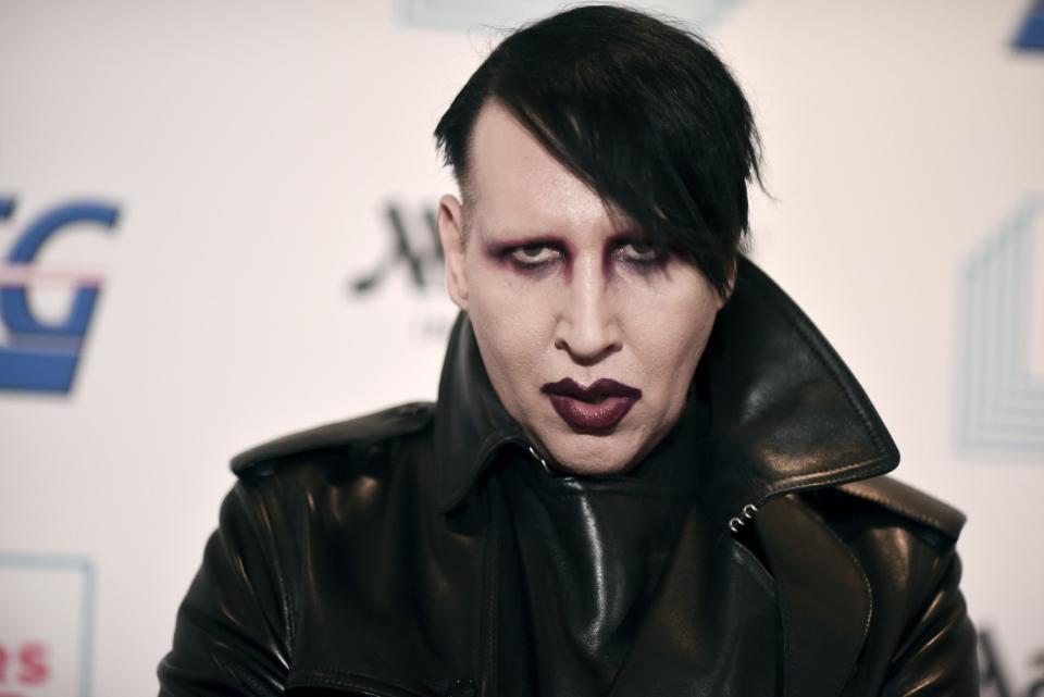 Marilyn Manson in goth makeup and a black leather jacket