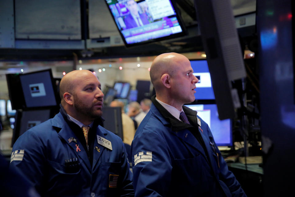 Traders work on the floor at the New York Stock Exchange (NYSE) in Manhattan, New York, U.S., December 28, 2017. REUTERS/Andrew Kelly