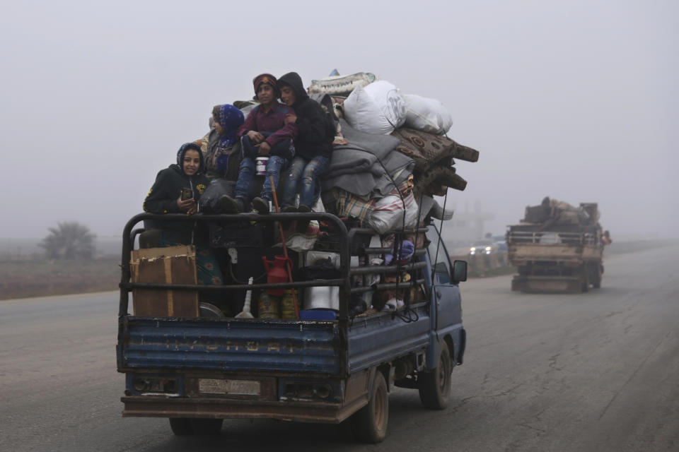 FILE - This Dec. 23, 2019, file photo, civilians ride in a truck as they flee Maaret al-Numan, Syria, ahead of a government offensive. The M5 highway, recaptured by President Bashar Assad’s forces, is arguably the most coveted prize in Syria’s civil war. The strategic highway is vital for Syria’s economy as well as for moving troops. (AP Photo/Ghaith Alsayed, File)