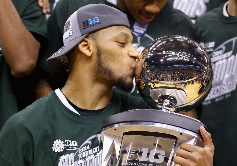 Adreian Payne #5 of the Michigan State Spartans kisses the trophy after the 69-55 win over the Michigan Wolverines during the finals of the Big Ten Basketball Tournament at Bankers Life Fieldhouse on March 16, 2014 in Indianapolis, Indiana. - Credit: Andy Lyons/Getty Images