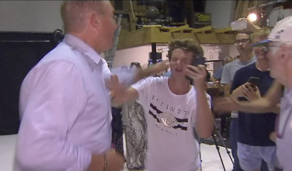 In this image made from video, Senator Fraser Anning swipes at a teenager who broke an egg on his head while he was holding a press conference, Saturday, March 16, 2019, in Melbourne, New Zealand. Following the mass shootings on Friday, Anning came under sharp criticism over tweets including one that said: “Does anyone still dispute the link between Muslim immigration and violence?” (AP Photo)