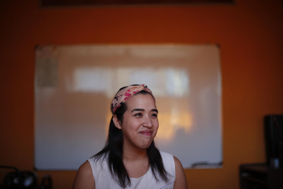 Transgender woman Fabiana Rodriguez smiles during an interview where she works as a teacher at the English Institute in Buenos Aires, Argentina, Friday, Nov. 13, 2020. Rodríguez said that even though she has a job, education, and family, that she wouldn’t be happy if she can’t be who she really is. (AP Photo/Natacha Pisarenko)