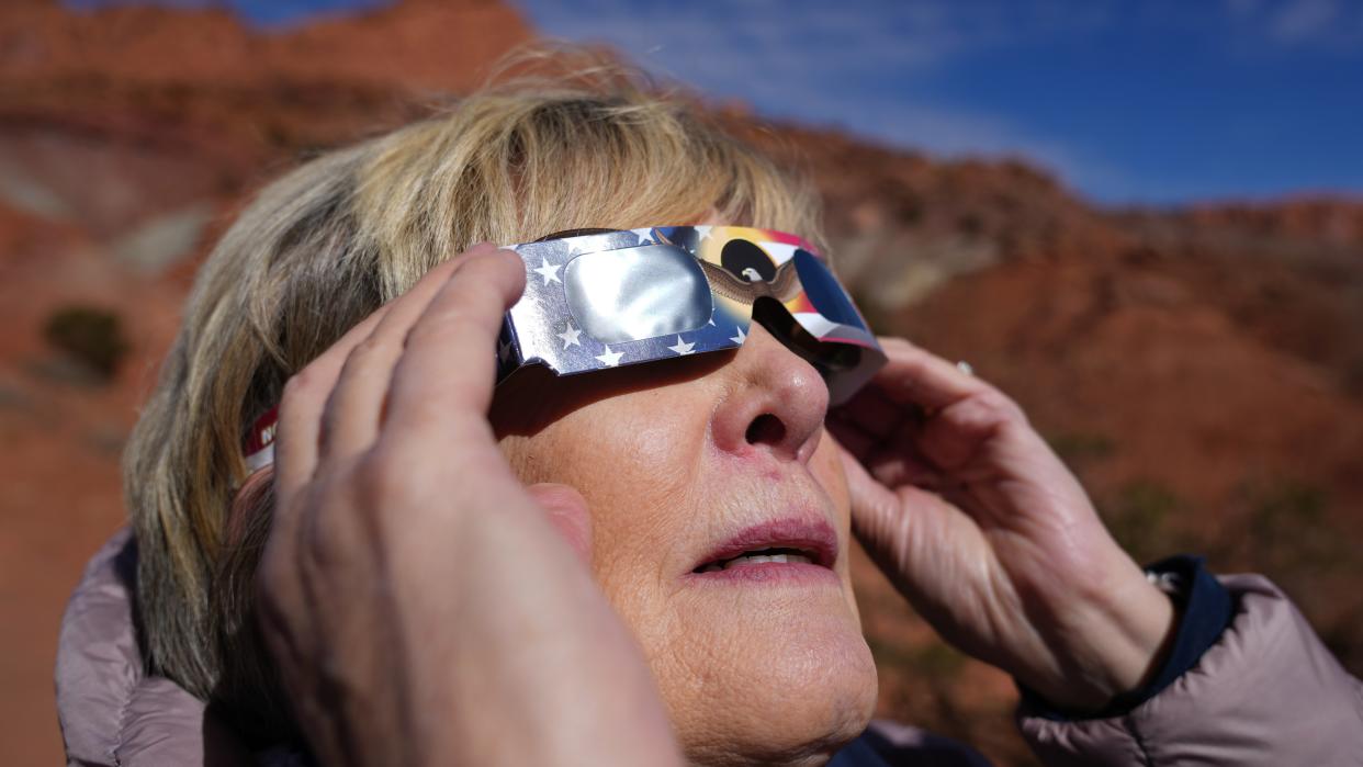  Woman viewing solar eclipse. 