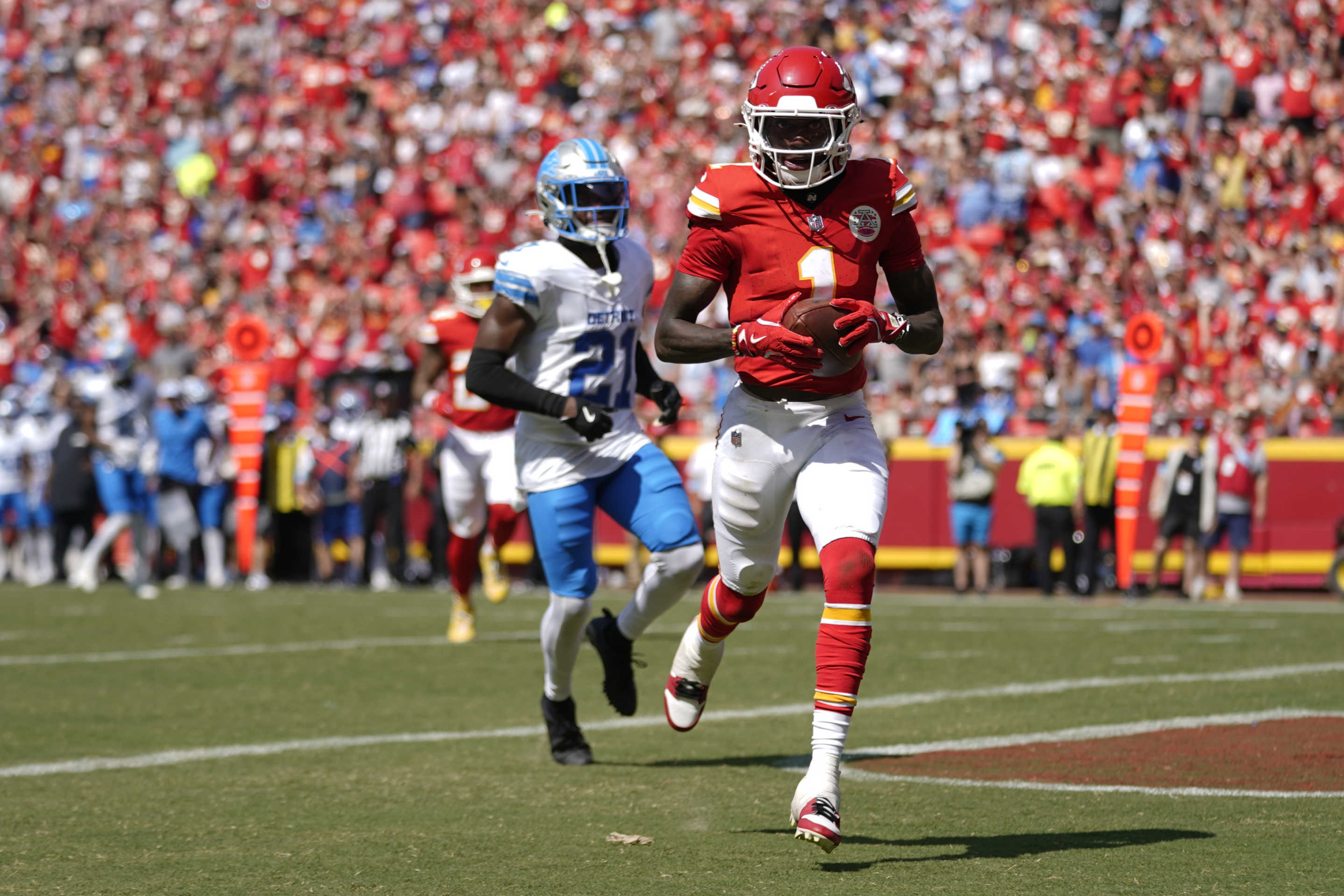 Kansas City Chiefs wide receiver Xavier Worthy (1) runs into the end zone for a touchdown after a catch against Detroit Lions cornerback Amik Robertson (21) during the first half of an NFL preseason football game Saturday, Aug. 17, 2024, in Kansas City, Mo. (AP Photo/Ed Zurga)