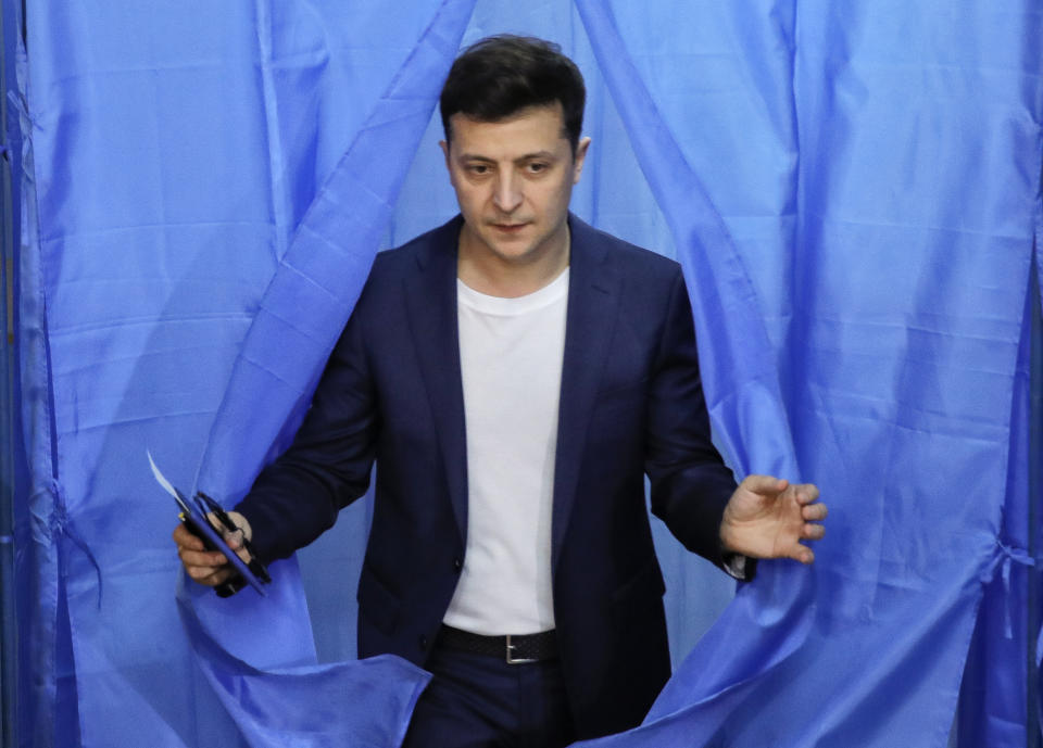 FILE - In this Sunday, April 21, 2019 file photo, Ukrainian comedian and presidential candidate Volodymyr Zelenskiy leaves a booth at a polling station during the second round of presidential elections in Kiev, Ukraine. Volodymyr Zelenskiy, who takes the presidential oath on Monday May 20, 2019, comes into the post having never held political office; his popularity is rooted in playing the role of president on a television sit-com. (AP Photo/Vadim Ghirda, File)