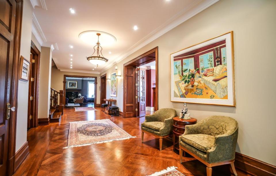 <p>When you enter, you can see straight into the grand dining room, flanked by the western and eastern wings of the home. (Listing via <span>Royal LePage</span>) </p>