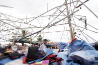 A man sits at his damaged shop in the aftermath of typhoon Haiyan in Vietnam's northern Quang Ninh province, 180 km (112 miles) from Hanoi November 11, 2013.